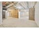 Unfinished basement space with concrete floor, exposed ceiling, and framed wall to create future living space at 5128 Preserve Pl, Firestone, CO 80504