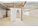 Unfinished basement featuring concrete flooring and stairs leading to the upper level; ready for customization at 5128 Preserve Pl, Firestone, CO 80504