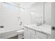 Bright white bathroom with tub, shower, and vanity with modern fixtures at 5128 Preserve Pl, Firestone, CO 80504