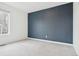 Bright bedroom featuring a dark accent wall and a window with natural light at 5128 Preserve Pl, Firestone, CO 80504
