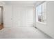 Well-lit bedroom features a double door closet and a large window, creating an open and airy atmosphere at 5128 Preserve Pl, Firestone, CO 80504