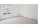 Bright bedroom with a large window and plush carpet, offering a comfortable and inviting space at 5128 Preserve Pl, Firestone, CO 80504