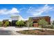 Exterior view of community clubhouse with modern architecture, landscaping, and ample parking at 5128 Preserve Pl, Firestone, CO 80504