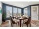 Bright dining room with large windows, modern table set and stylish decor at 5128 Preserve Pl, Firestone, CO 80504