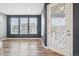 Bright dining room with large windows and glass door with decorative design at 5128 Preserve Pl, Firestone, CO 80504