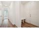 Bright hallway with wood-look flooring, a built-in bench, and access to other rooms at 5128 Preserve Pl, Firestone, CO 80504