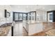 Modern kitchen featuring granite island, stainless steel appliances, and hardwood floors at 5128 Preserve Pl, Firestone, CO 80504