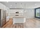 Bright kitchen featuring granite countertops, stainless steel appliances, and modern lighting at 5128 Preserve Pl, Firestone, CO 80504