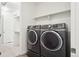Practical laundry room features full-size washer and dryer units, and a closet for ample storage space at 5128 Preserve Pl, Firestone, CO 80504