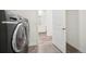 Laundry room featuring modern washer and dryer with light wood-look flooring and white walls at 5128 Preserve Pl, Firestone, CO 80504