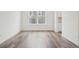 Open concept living room with beautiful wood laminate flooring and ample natural light at 5128 Preserve Pl, Firestone, CO 80504