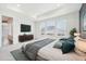 Spacious main bedroom boasts tray ceiling, large windows, and contemporary decor at 5128 Preserve Pl, Firestone, CO 80504
