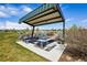 Community picnic area featuring picnic tables under a sheltered canopy, perfect for outdoor dining and gatherings at 5128 Preserve Pl, Firestone, CO 80504