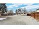 Spacious backyard featuring a large gravel area, concrete patio, and a privacy fence around the perimeter at 1852 S Forest St, Denver, CO 80222