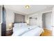 Grey bedroom with hardwood floors features an open closet, two side tables and a full bed at 1852 S Forest St, Denver, CO 80222