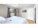 Bedroom features hardwood floors, grey walls, a full bed, and a television mounted on the wall at 1852 S Forest St, Denver, CO 80222