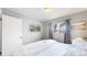 Grey bedroom with hardwood floors features a wall-mounted television, and a full bed at 1852 S Forest St, Denver, CO 80222