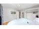 Grey bedroom with hardwood floors features an open closet, wall-mounted television, and a full bed at 1852 S Forest St, Denver, CO 80222