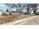 Charming single-story home with beige siding, blue door, and landscaped front yard with mature trees at 1852 S Forest St, Denver, CO 80222