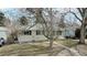 Cozy home featuring a well-manicured lawn and mature trees offering shade and curb appeal at 1852 S Forest St, Denver, CO 80222
