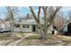 Charming home with a lovely front yard featuring mature trees, sidewalks, and easy street parking at 1852 S Forest St, Denver, CO 80222