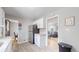 Spacious kitchen area with stainless steel refrigerator, white cabinets, and view to the living room at 1852 S Forest St, Denver, CO 80222