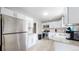 Modern kitchen featuring stainless steel appliances, white cabinets, and granite countertops at 1852 S Forest St, Denver, CO 80222