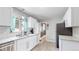 Kitchen with stone countertops, stainless dishwasher and refrigerator, and white tile backsplash at 1852 S Forest St, Denver, CO 80222