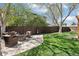 Spacious backyard with a seating area, a grill, lush lawn, and a privacy fence at 10889 Alcott Ct, Denver, CO 80234