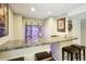 Finished basement bar with a marble countertop and stocked bar with display shelves at 10889 Alcott Ct, Denver, CO 80234