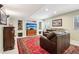 Finished basement living area with a plush sofa, built-in shelving, and modern lighting at 10889 Alcott Ct, Denver, CO 80234