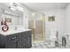 Bathroom with a modern vanity, decorative tile floor, and a glass enclosed shower at 10889 Alcott Ct, Denver, CO 80234