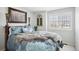 Comfortable bedroom with a large bed, fur throw, and shuttered window at 10889 Alcott Ct, Denver, CO 80234