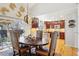 Dining area with a large table, kitchen view, and access to the outdoor space through sliding doors at 10889 Alcott Ct, Denver, CO 80234
