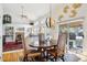 Cozy dining area with an elegant chandelier, a view of the living room, and sliding glass doors at 10889 Alcott Ct, Denver, CO 80234