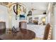 Stylish dining room featuring a unique chandelier, view of the living room fireplace, and warm lighting at 10889 Alcott Ct, Denver, CO 80234