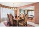 Traditional dining room features a chandelier, formal table and chairs, and classic decor at 10889 Alcott Ct, Denver, CO 80234