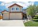 Charming two-story home with a three-car garage, brick accents, and a well-manicured lawn at 10889 Alcott Ct, Denver, CO 80234