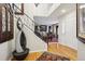 Inviting foyer with hardwood floors, elegant staircase, and unique decorative water feature at 10889 Alcott Ct, Denver, CO 80234