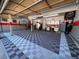 Well-organized garage with storage cabinets and a patterned floor at 10889 Alcott Ct, Denver, CO 80234