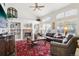 Spacious living room featuring a brick fireplace, built-in shelving, and large windows at 10889 Alcott Ct, Denver, CO 80234