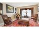 The cozy living room features leather furniture, a large window, and traditional decor at 10889 Alcott Ct, Denver, CO 80234