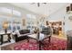Open-concept living room with a kitchen view, vaulted ceilings, and large windows for natural light at 10889 Alcott Ct, Denver, CO 80234