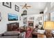 Bright living room with a brick fireplace, built-in shelves, and comfortable leather seating at 10889 Alcott Ct, Denver, CO 80234