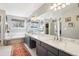 The modern main bathroom features a tub, double vanity, and natural light at 10889 Alcott Ct, Denver, CO 80234