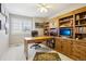 Functional office with built-in shelves and a wooden desk at 10889 Alcott Ct, Denver, CO 80234