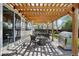 Covered patio with a dining area, fire pit, built-in grill, and outdoor seating at 10889 Alcott Ct, Denver, CO 80234