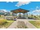 Outdoor pavilion with a fireplace, picnic tables, and grills, perfect for community events at 21032 E 63Rd Dr, Aurora, CO 80019