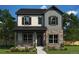 Charming two-story home with stone accents, welcoming front porch and professional landscaping at 21032 E 63Rd Dr, Aurora, CO 80019