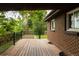 Wooden deck showcasing outdoor living space, brick siding, and metal railing at 654 S Shoshone St, Denver, CO 80223